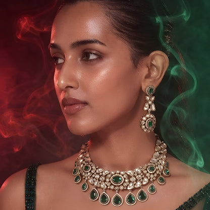 "Gold-tone Kundan choker necklace set with emerald green teardrop drops and matching earrings"