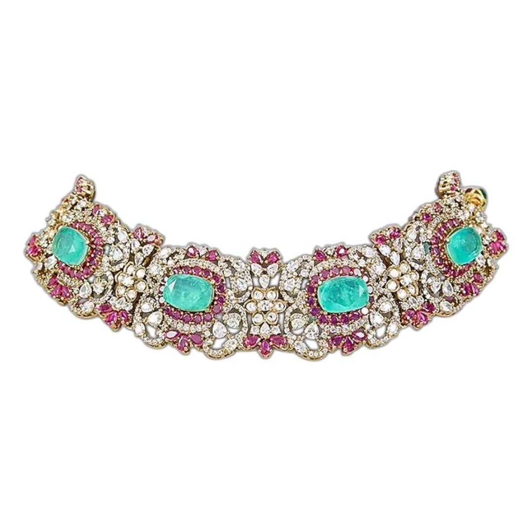 Luxury emerald green kundan choker necklace set with sparkling polki stones, ruby pink accents, and matching chandelier earrings for bridal and wedding wear.