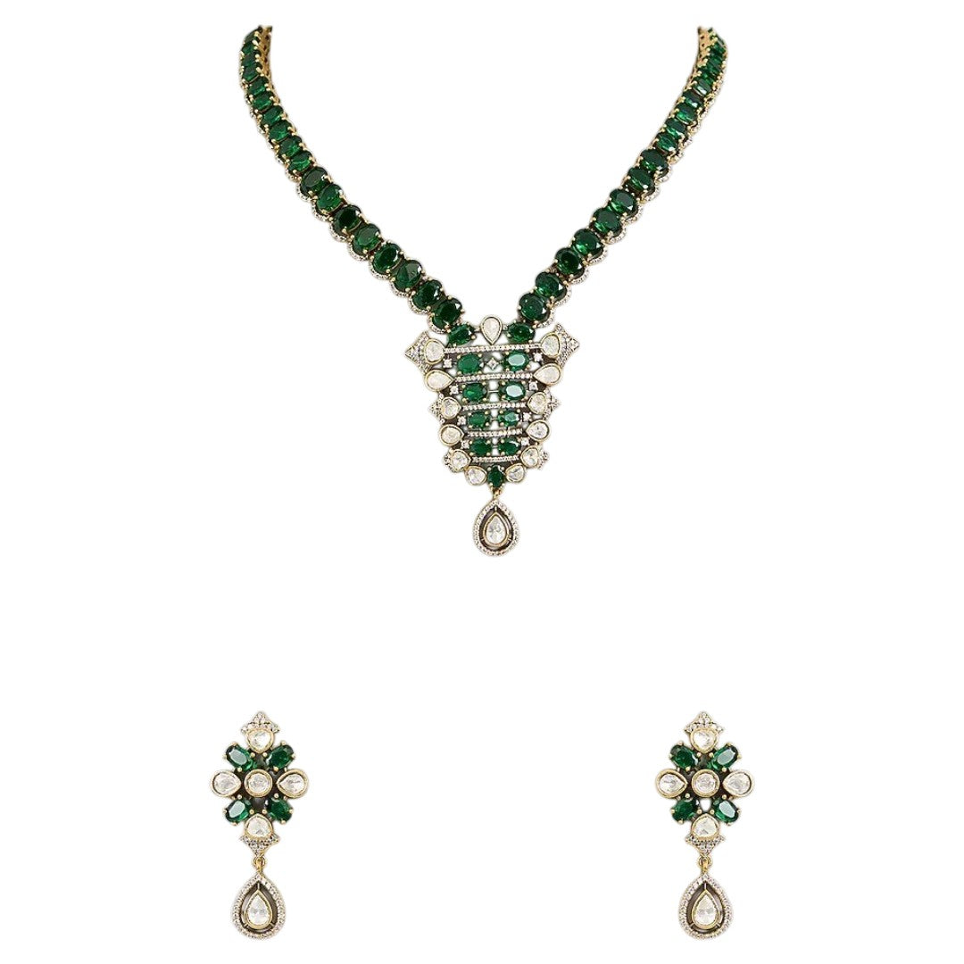 "Emerald green Kundan-style necklace and earring set with antique gold finish and white stone accents"