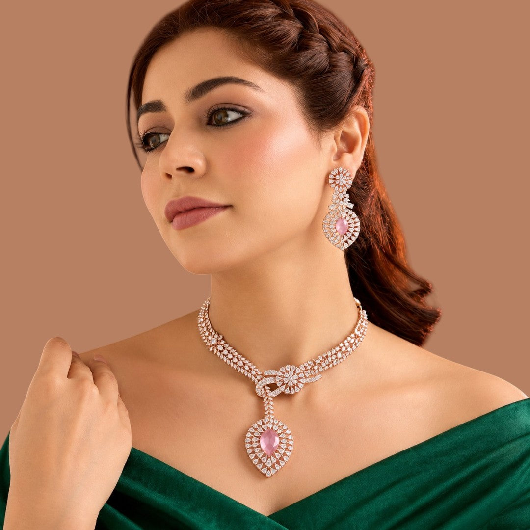 Rose gold plated pink American diamond necklace set with knot design, pink pear drop pendant and matching earrings