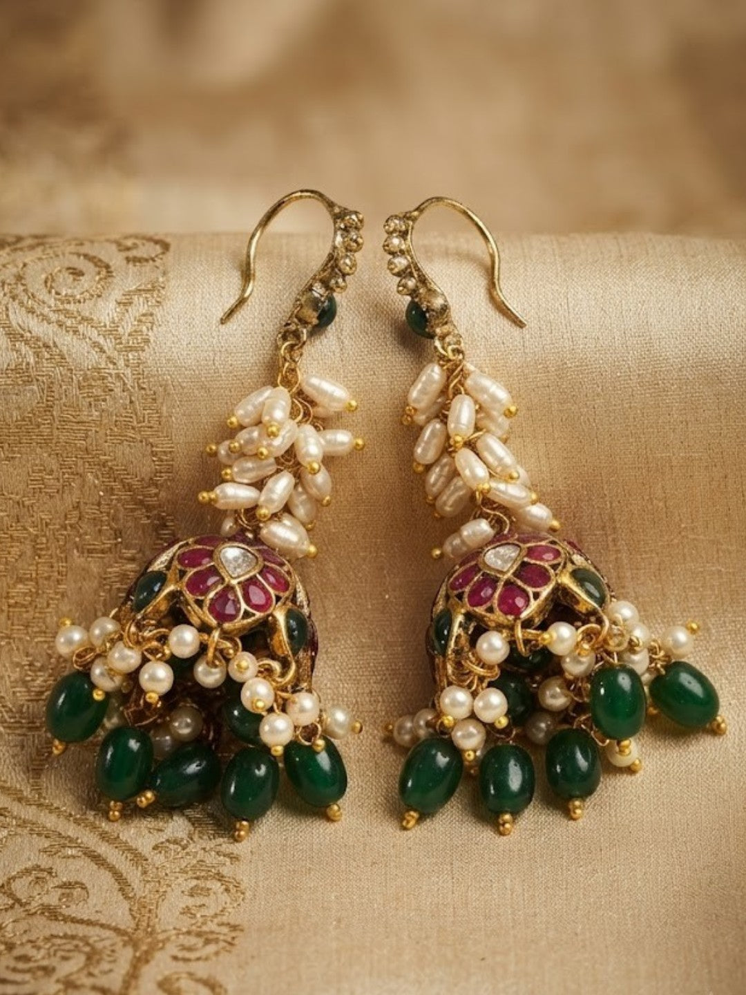 Antique gold jhumka earrings with rice pearl cluster, ruby pink floral dome and green bead drops