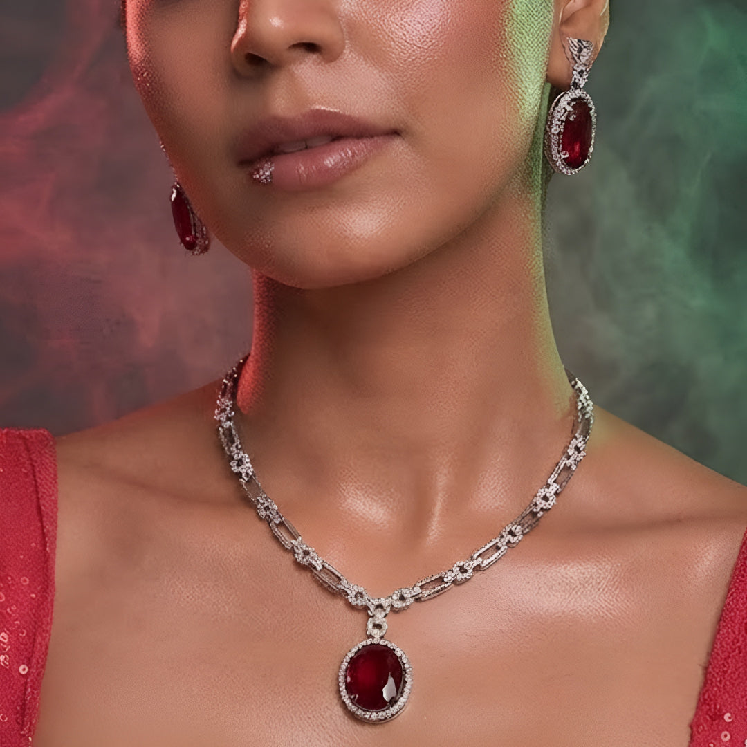 Silver plated American Diamond necklace set with ruby red oval pendant and matching drop earrings
