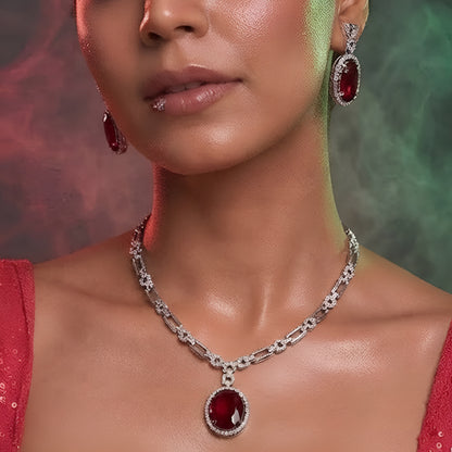 Silver plated American Diamond necklace set with ruby red oval pendant and matching drop earrings