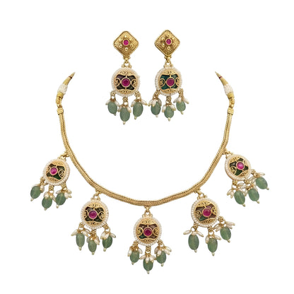 Antique gold plated choker necklace set with ruby pink medallions, mint green bead and pearl drops and matching earrings on a blue bust