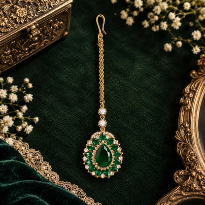 Gold finish American diamond maang tikka with emerald green pear centre stone, green marquise floral border, zircon accents and delicate chain – Auraa Trends