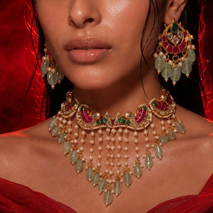 "Gold-plated Kundan Meenakari choker necklace and earring set with pearl and green bead drops, styled bridal jewellery on model"