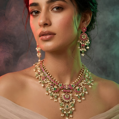 Pink and green Kundan-style necklace set with statement pendant and matching earrings