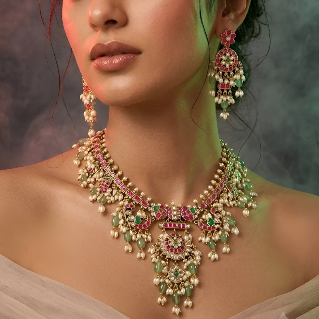 Pink and green Kundan-style necklace set with statement pendant and matching earrings