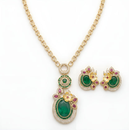Gold-tone American diamond link chain necklace with a large oval emerald-green flower pendant and matching earring on a grey display bust