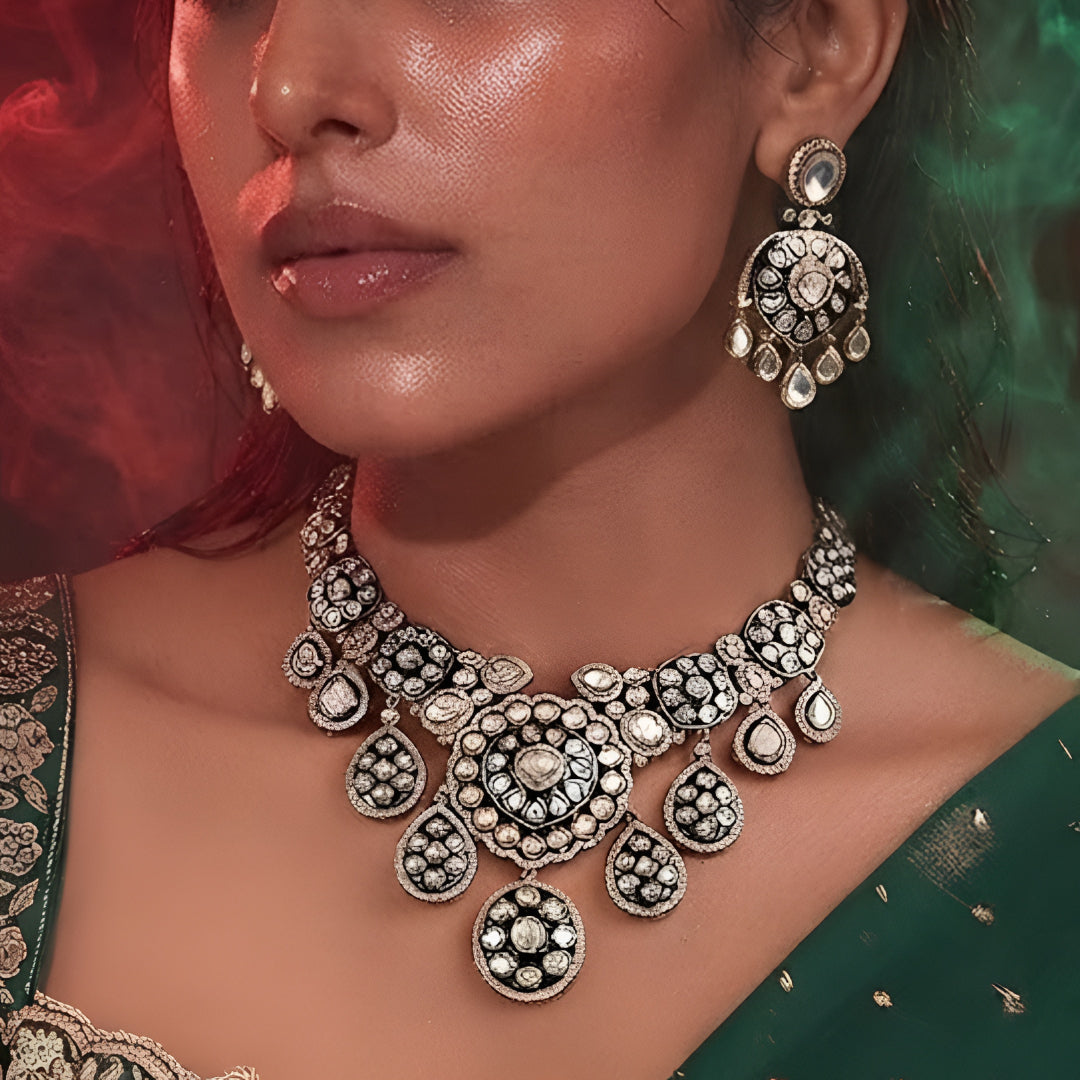 "Antique gold Kundan choker necklace with green meenakari enamel and polki stone medallions, matching disc drop earrings"