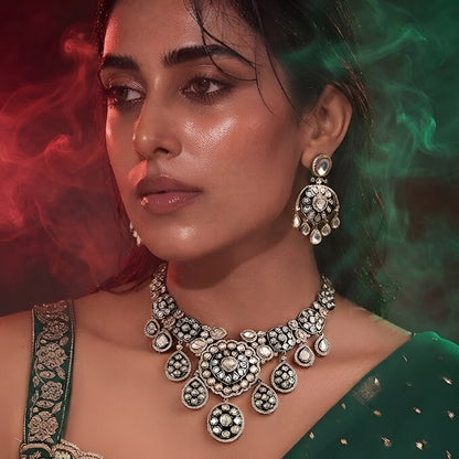 "Antique gold Kundan choker necklace with green meenakari enamel and polki stone medallions, matching disc drop earrings"