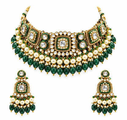 Gold kundan choker necklace set with green meenakari motifs, pearl and green bead drops and matching chandelier earrings on brown bust