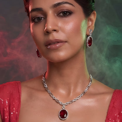Silver plated American Diamond necklace set with ruby red oval pendant and matching drop earrings