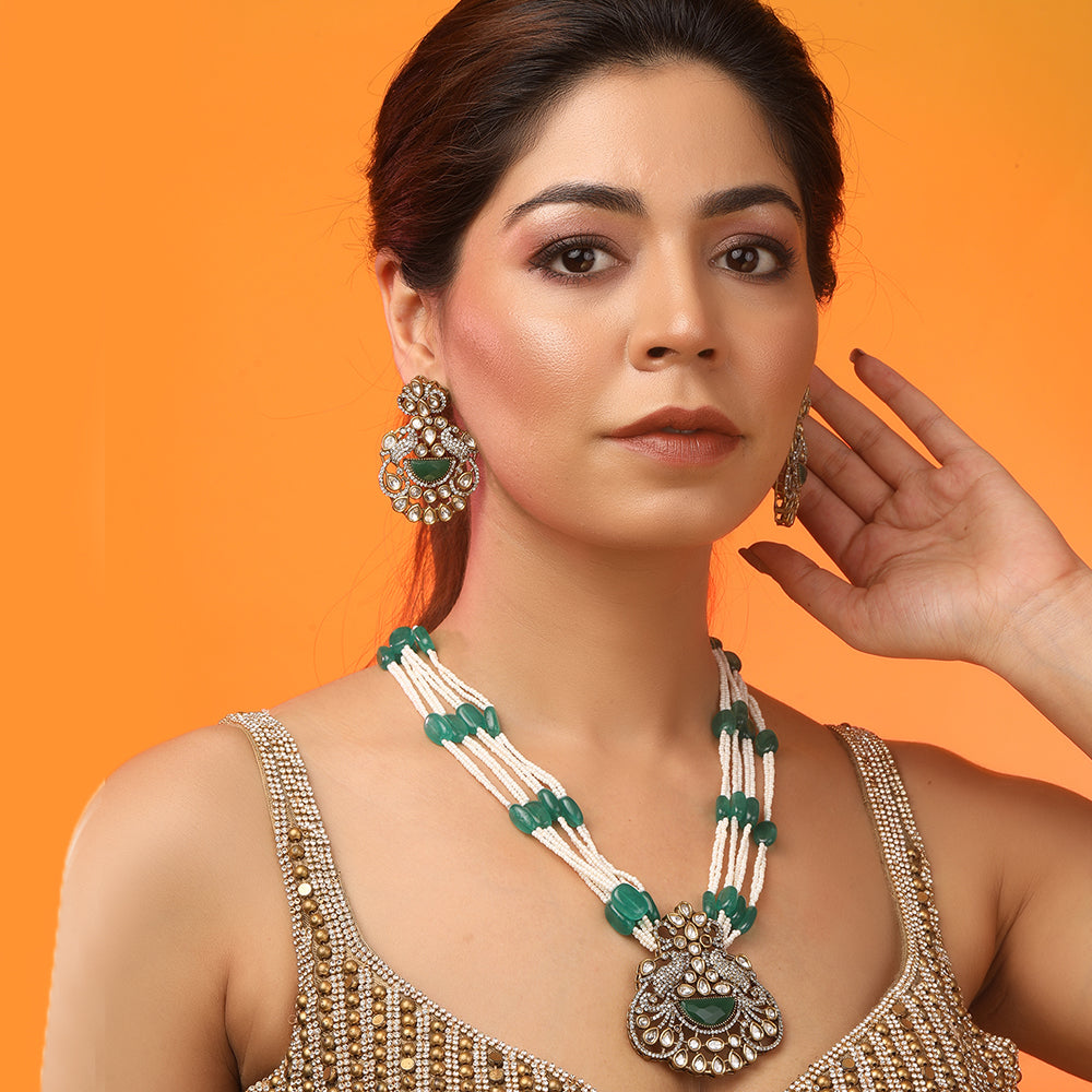 Green beaded Kundan long necklace set with pearl strands and matching traditional earrings for bridal and festive wear