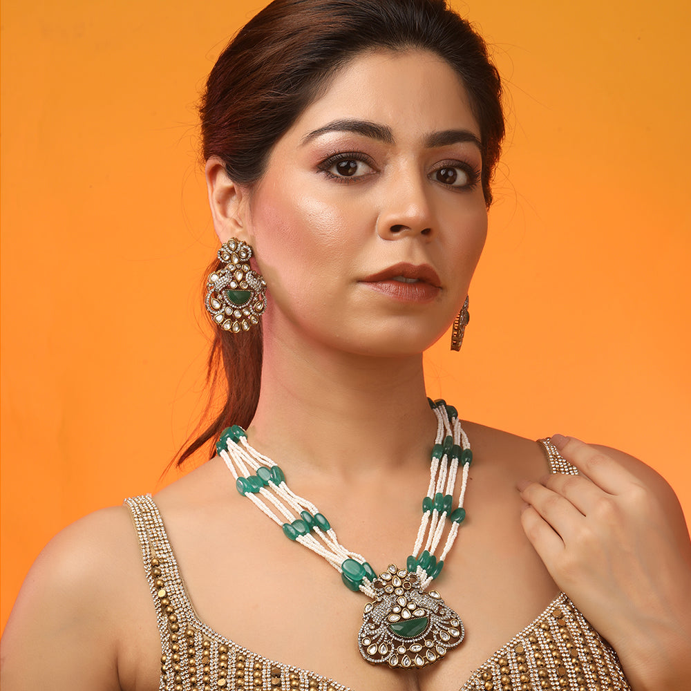 Green beaded Kundan long necklace set with pearl strands and matching traditional earrings for bridal and festive wear