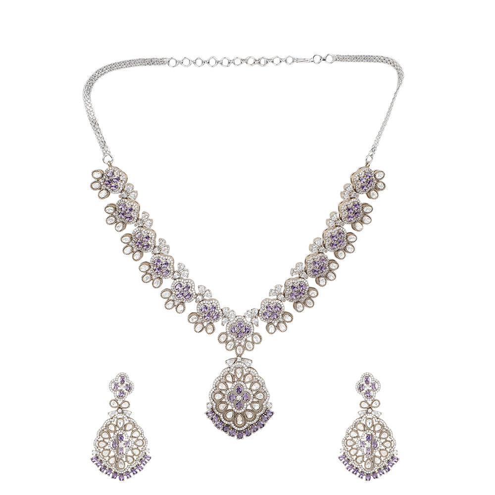 Silver plated necklace set with purple stones and matching earrings featuring intricate floral design for party and bridal wear