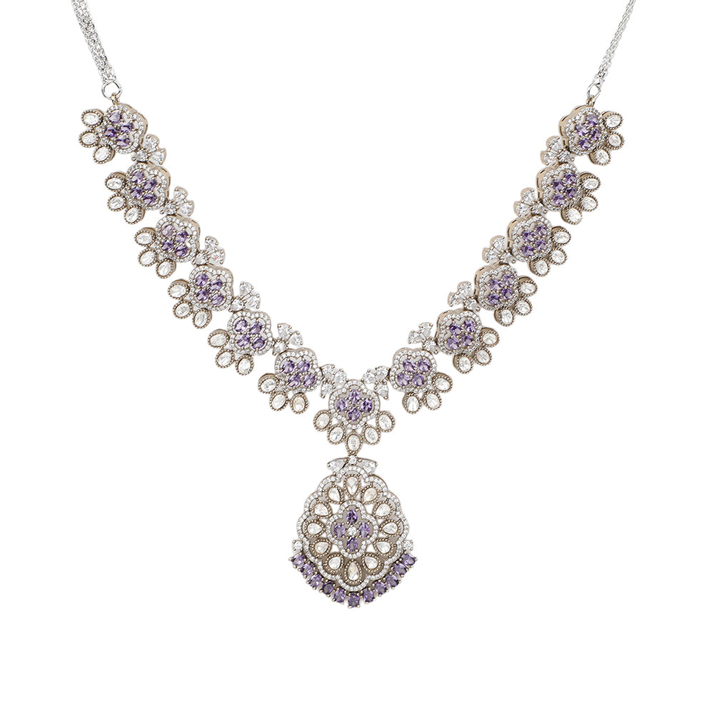 Silver plated necklace set with purple stones and matching earrings featuring intricate floral design for party and bridal wear