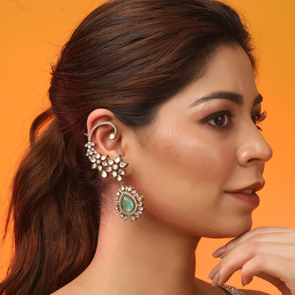 Gold floral kundan ear cuff earrings with green teardrop gemstone and intricate design
