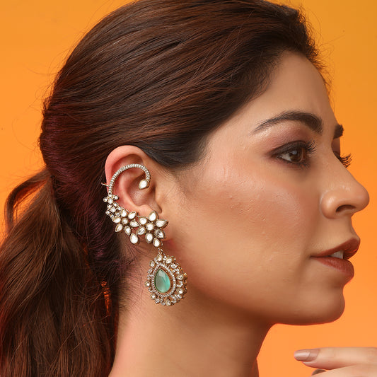 Gold floral kundan ear cuff earrings with green teardrop gemstone and intricate design