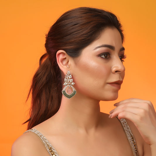 Gold plated American diamond earrings with leaf design, green stones and pink drop hanging centerpiece on white background