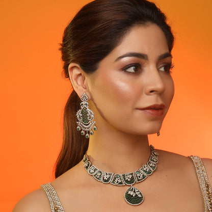 Gold plated statement necklace set with green stones and matching chandelier earrings for bridal and festive wear