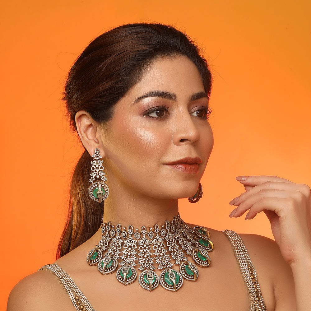 Gold plated choker necklace set with green stones and matching long earrings for bridal and party wear