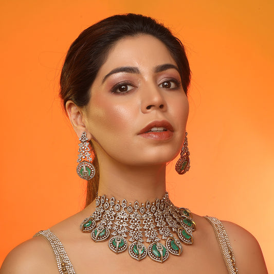 Gold plated choker necklace set with green stones and matching long earrings for bridal and party wear