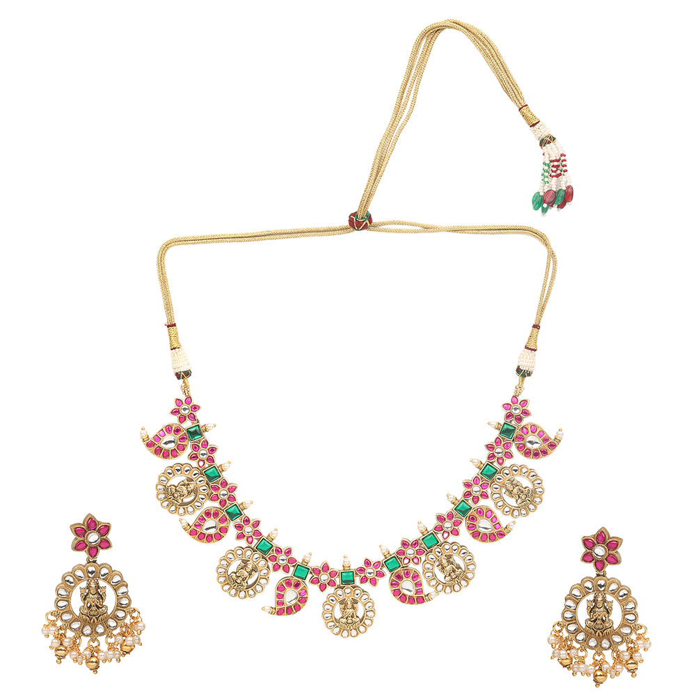 Gold plated temple Lakshmi necklace set with pink and green stones and matching earrings with pearl drops on white background
