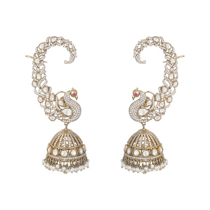 Gold plated peacock design jhumka earrings with American diamonds and pearl drops on white background
