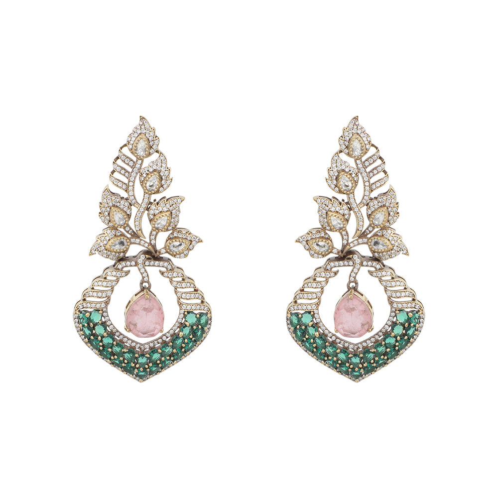 Gold plated American diamond earrings with leaf design, green stones and pink drop hanging centerpiece on white background