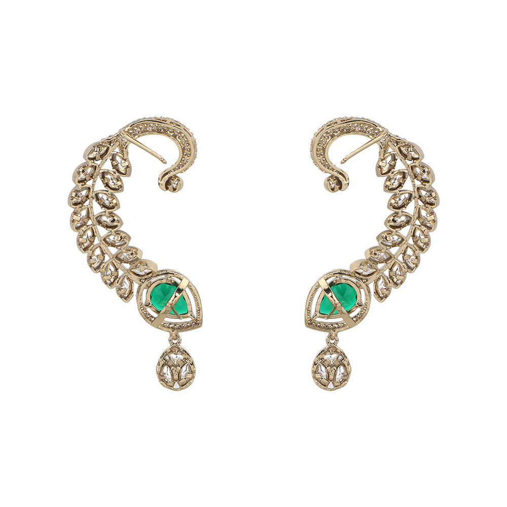 Gold plated American diamond ear cuff earrings with green teardrop stone and leaf design on white background