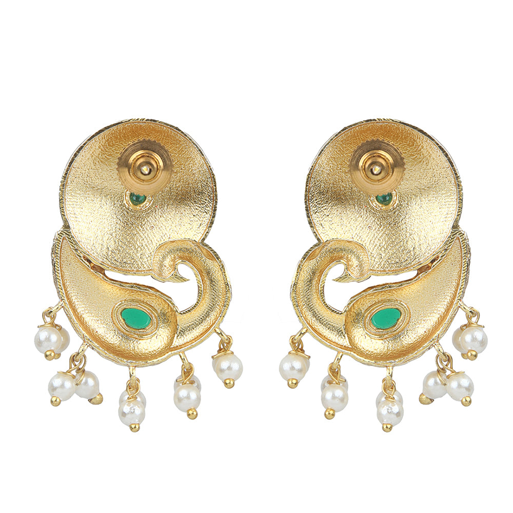 Gold peacock temple earrings with green stone accents and pearl drop detailing on neutral background