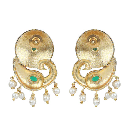 Gold peacock temple earrings with green stone accents and pearl drop detailing on neutral background