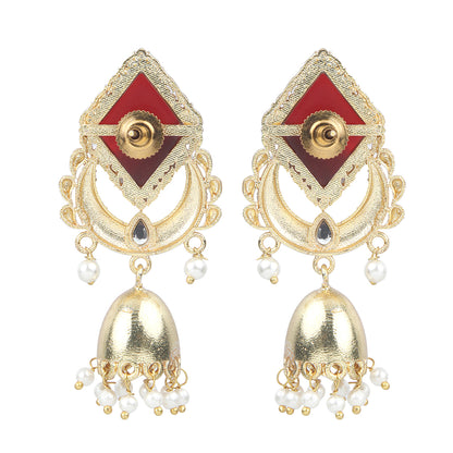 Gold jhumka earrings with red gemstone top, circular design, and pearl drop danglers on neutral background