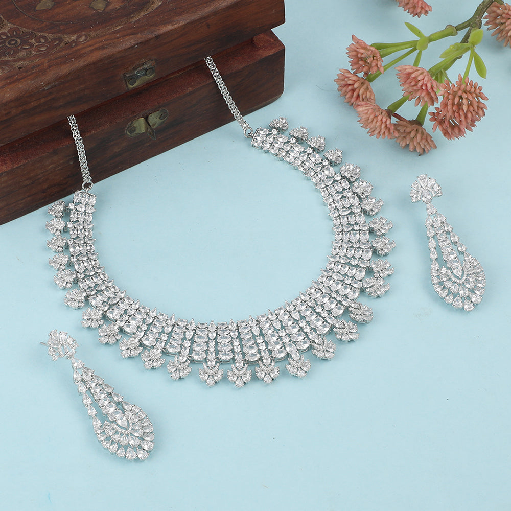 Silver American diamond necklace set with heart-shaped drop design and matching long earrings on white background
