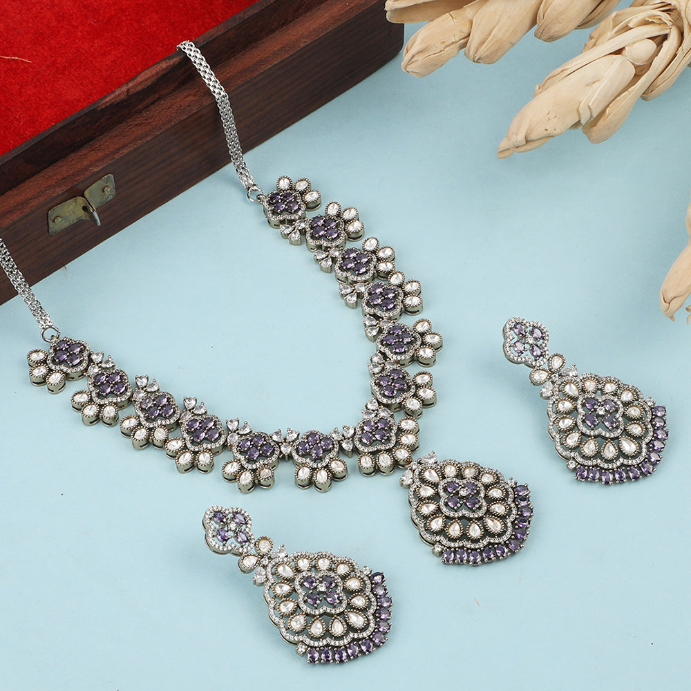 Silver plated necklace set with purple stones and matching earrings featuring intricate floral design for party and bridal wear