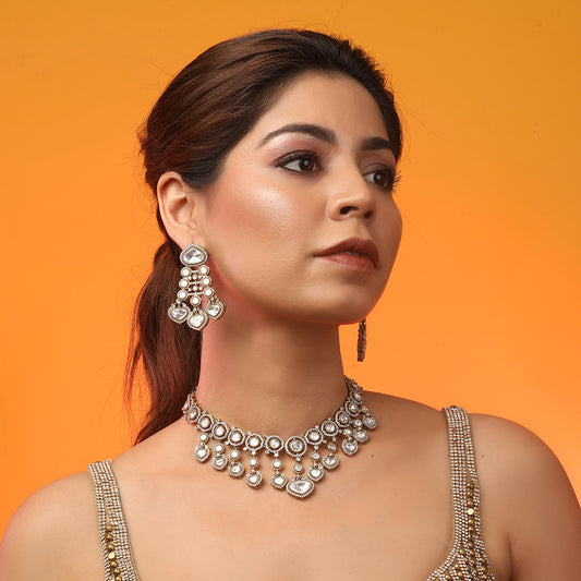 Gold plated Kundan necklace set with white stones and matching chandelier earrings for bridal and festive wear