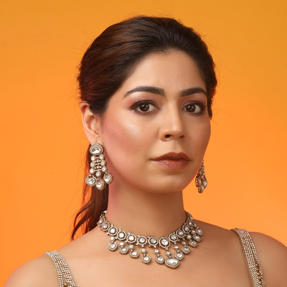 Gold plated Kundan necklace set with white stones and matching chandelier earrings for bridal and festive wear