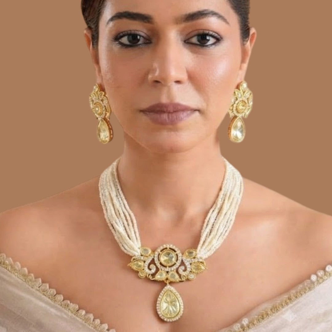 Gold-finish multi-strand seed pearl polki necklace set with pear-shaped polki pendant drop and matching stud earrings