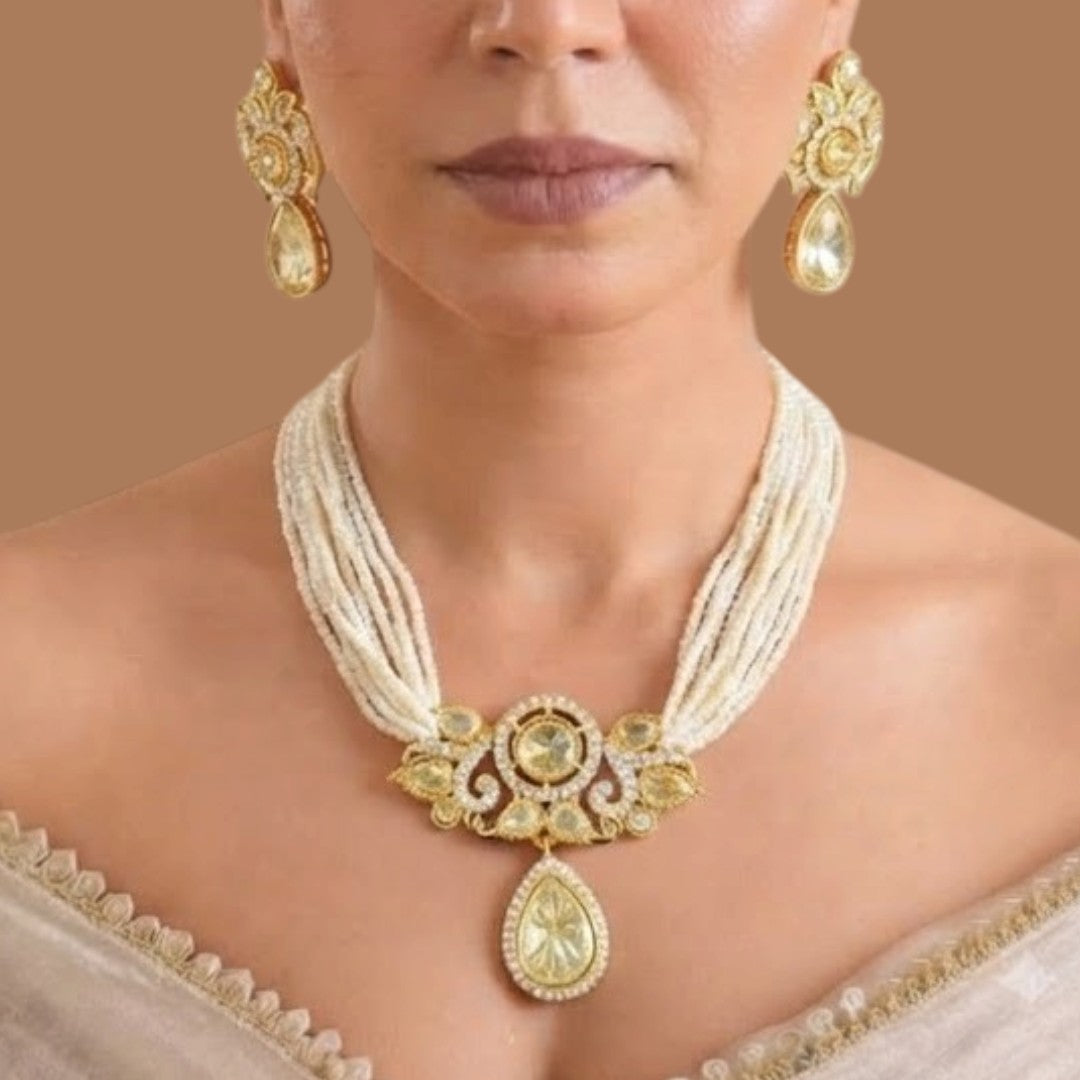 Gold-finish multi-strand seed pearl polki necklace set with pear-shaped polki pendant drop and matching stud earrings