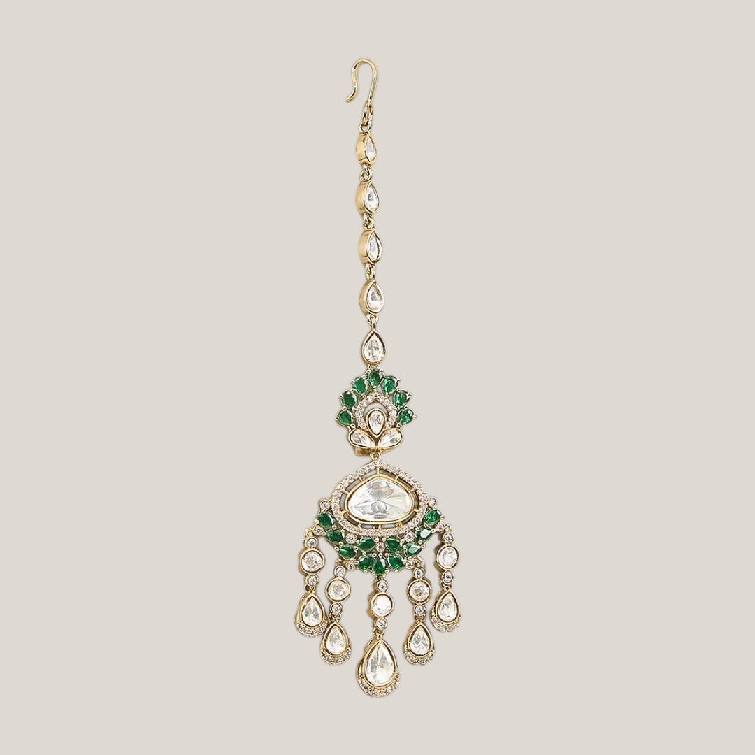 Gold finish kundan polki maang tikka with emerald green pear-stone fan, large clear centre stone, American diamond halo and chandelier-style kundan drops – Auraa Trends