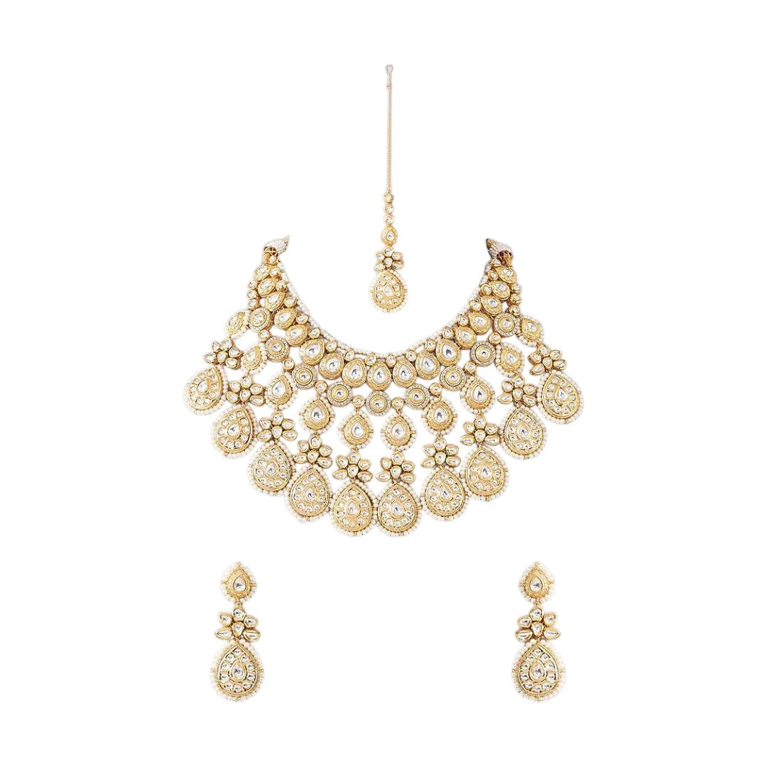 Gold-toned bridal kundan necklace set with pearl edging, maang tikka, and matching jhumka earrings