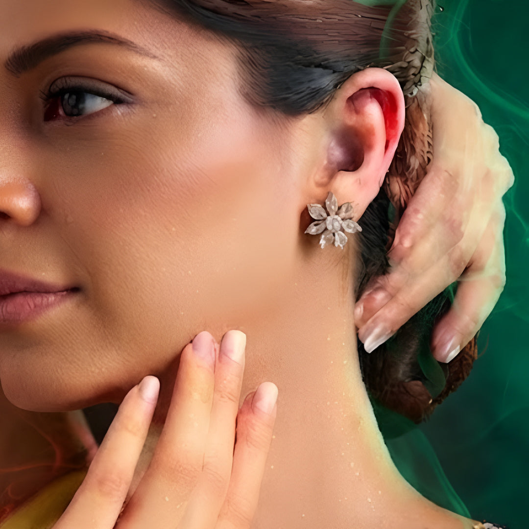 Gold-tone flower-shaped stud earrings with iridescent faceted crystal stones, front-facing pair