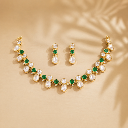 Gold-plated necklace set with green round stones, white teardrop crystal stones, and matching stud earrings for women, ideal for party, festive, and wedding wear.