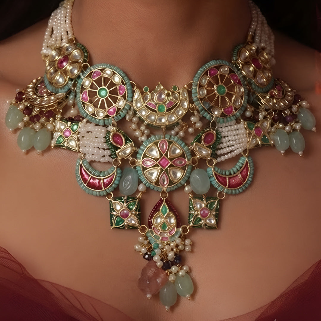 "Antique gold multicolor Kundan necklace and earring set with turquoise pink meenakari medallions, pearl tassel closure and mint bead drops, traditional jewellery on maroon backdrop"