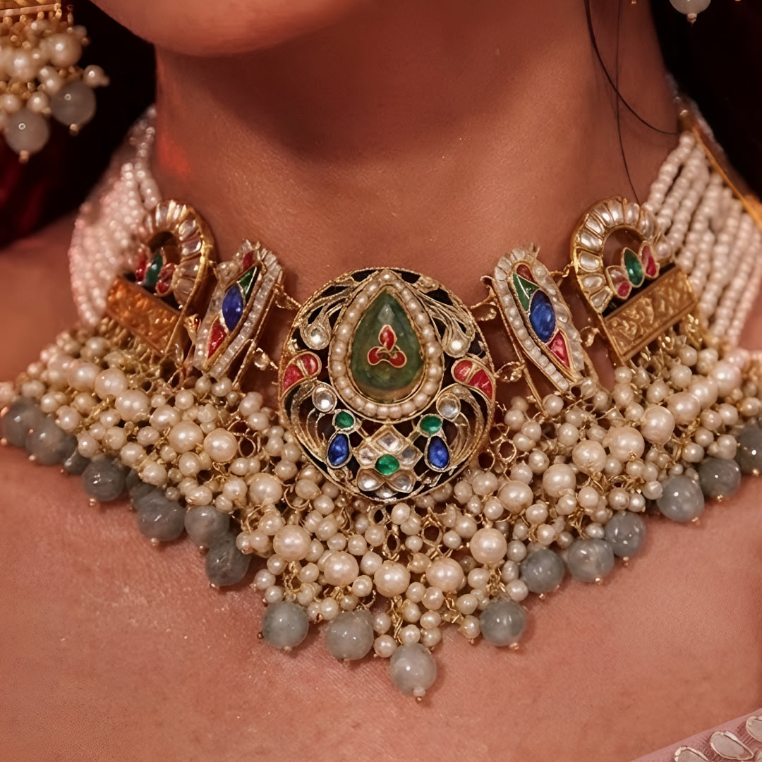 "Antique gold multi-strand pearl beaded necklace and earring set with meenakari enamel work and grey bead drops, temple jewellery on maroon backdrop"