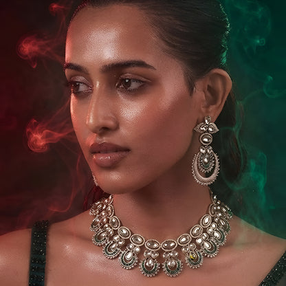 "Antique gold Kundan choker necklace with green baguette crescent accents and matching chandbali drop earrings"