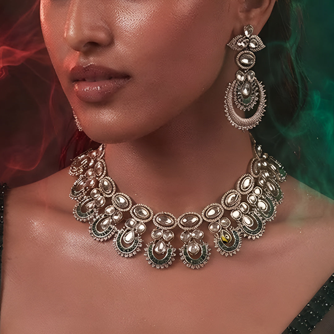 "Antique gold Kundan choker necklace with green baguette crescent accents and matching chandbali drop earrings"