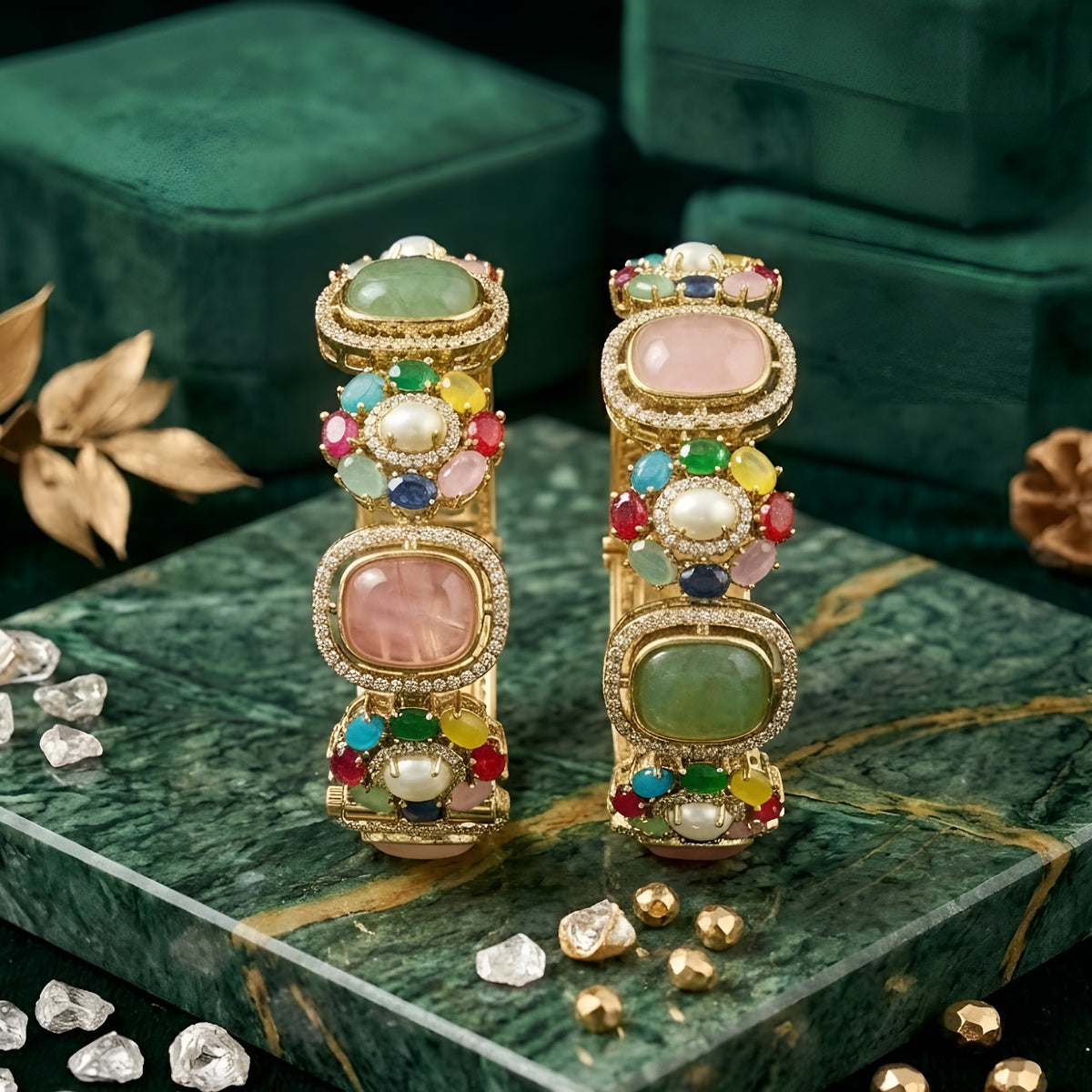 Pair of gold-finish openable kada bangles with pink and green cushion-cut stones, multicolour floral motifs, pearl-style centres, and American diamond frames