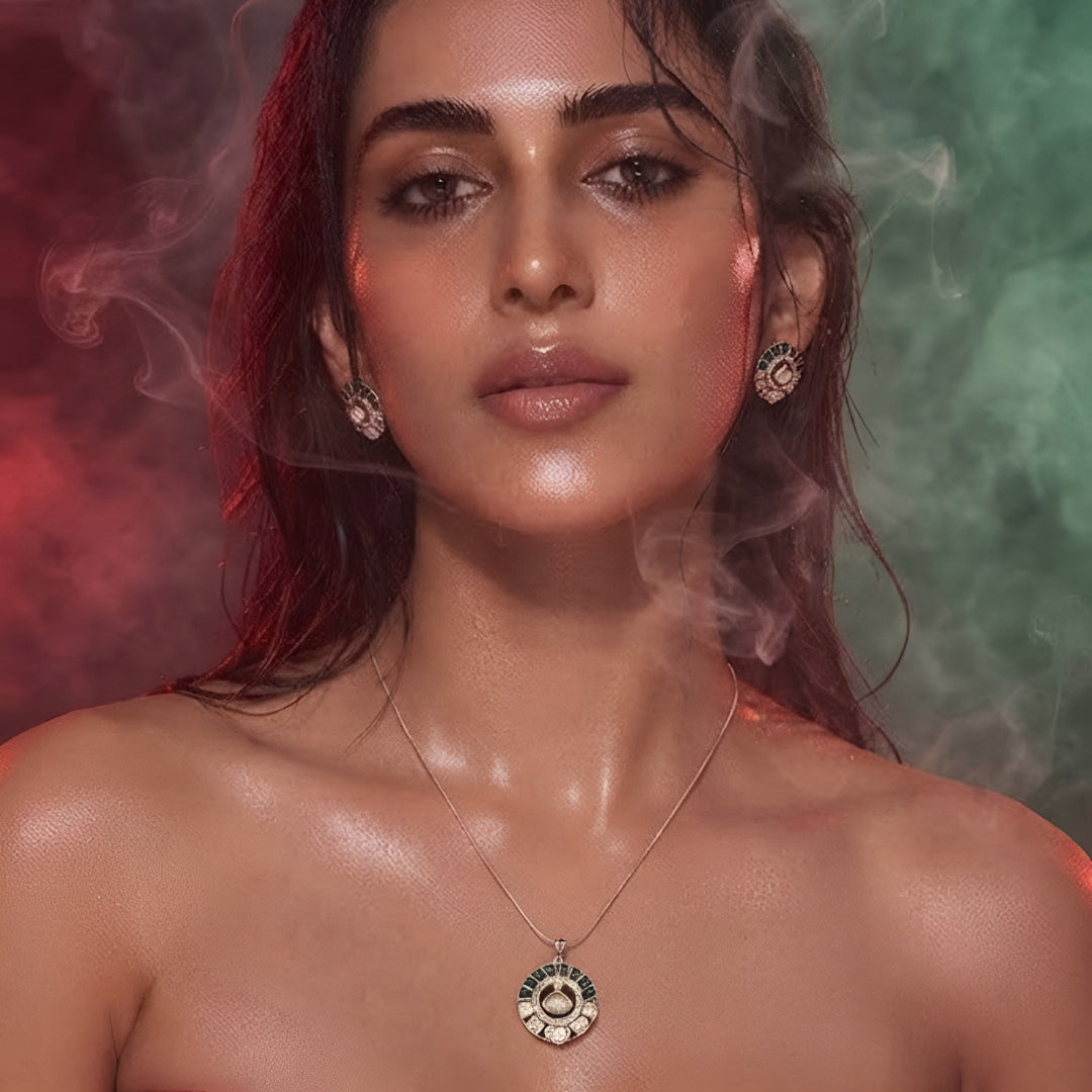 "Gold-tone kundan polki necklace and earring set with emerald-green enamel detailing and round uncut diamond-style pendant, on white background"